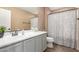 Bathroom with a large mirror, white cabinets, and a shower with a patterned curtain at 2607 W Gray Wolf Trl, Phoenix, AZ 85085