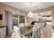 Open concept dining area with wood table, white chairs, chandelier, and view to the kitchen and living room at 2607 W Gray Wolf Trl, Phoenix, AZ 85085