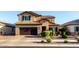 Attractive two-story home with a landscaped front yard, complemented by a brown garage door and well-maintained lawn at 2607 W Gray Wolf Trl, Phoenix, AZ 85085