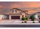 Charming two-story home with a brown garage door and desert landscaping, providing curb appeal at 2607 W Gray Wolf Trl, Phoenix, AZ 85085