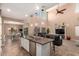 Spacious open floor plan with kitchen featuring island with bar, stainless steel appliances, open to living and dining areas at 2607 W Gray Wolf Trl, Phoenix, AZ 85085