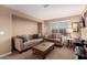 Cozy living room with two sofas, carpet, and large windows at 2607 W Gray Wolf Trl, Phoenix, AZ 85085