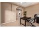 Well-lit home office with tray ceiling, dark desk, and view to the hallway at 2607 W Gray Wolf Trl, Phoenix, AZ 85085