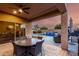 Inviting covered patio with an outdoor dining area overlooking a pool with waterfall feature at 2607 W Gray Wolf Trl, Phoenix, AZ 85085