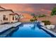Stunning backyard pool with a waterfall feature, complemented by lush landscaping and privacy walls at 2607 W Gray Wolf Trl, Phoenix, AZ 85085