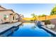 Stunning backyard pool with a tranquil waterfall feature, offering a refreshing oasis for relaxation and recreation at 2607 W Gray Wolf Trl, Phoenix, AZ 85085