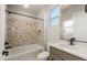 Stylish bathroom showcasing a tub with decorative tile, modern vanity, and sleek fixtures at 26914 W Renee Dr, Buckeye, AZ 85396