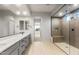 Bright bathroom showcasing dual sinks, a walk-in shower, and contemporary finishes at 26914 W Renee Dr, Buckeye, AZ 85396