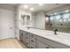 Modern bathroom features double vanity, quartz counters, grey cabinetry, and glass shower at 26914 W Renee Dr, Buckeye, AZ 85396