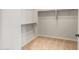 Empty carpeted walk-in closet with shelving provides ample storage space at 26914 W Renee Dr, Buckeye, AZ 85396