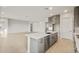 Bright kitchen features grey cabinets, quartz countertops, stainless appliances and a large island with seating at 26914 W Renee Dr, Buckeye, AZ 85396
