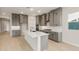 Bright kitchen features grey cabinets, quartz countertops, stainless appliances and a large island with seating at 26914 W Renee Dr, Buckeye, AZ 85396