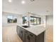 Bright kitchen features a large island with seating, quartz countertops, and stainless steel appliances at 26914 W Renee Dr, Buckeye, AZ 85396