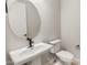 Cozy powder room featuring a pedestal sink, sleek fixtures, and minimalist design at 26914 W Renee Dr, Buckeye, AZ 85396
