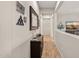 Hallway featuring wood look floors, console table and decor at 27276 N 81St Ln, Peoria, AZ 85383