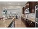 Stylish kitchen with stainless steel appliances, stone countertops and a view into the dining area at 27276 N 81St Ln, Peoria, AZ 85383
