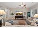 Comfortable living room with plush sofas, a decorative rug, and a large screen television at 27276 N 81St Ln, Peoria, AZ 85383