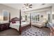 Serene main bedroom with a luxurious four-poster bed and elegant decor at 27276 N 81St Ln, Peoria, AZ 85383