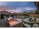 Lounge by the pool with a built in BBQ and grill, waterfall, and mountain views at 27276 N 81St Ln, Peoria, AZ 85383