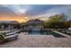 Beautiful backyard pool with water feature, lounge chairs, and mountain views at sunset at 27276 N 81St Ln, Peoria, AZ 85383