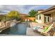 Backyard pool area with waterfall feature and lounge chairs at 27276 N 81St Ln, Peoria, AZ 85383