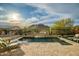 Backyard pool area with waterfall feature, lounge chairs and mountain views at 27276 N 81St Ln, Peoria, AZ 85383