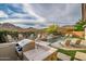 Backyard pool area with waterfall feature, built in grill and mountain views at 27276 N 81St Ln, Peoria, AZ 85383