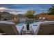 Relax and unwind in this pool setting with lounge chairs and waterfall feature at 27276 N 81St Ln, Peoria, AZ 85383