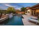 Backyard pool with water feature and outdoor seating area for ultimate relaxation at 27276 N 81St Ln, Peoria, AZ 85383