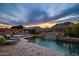 Luxury outdoor living with a beautiful pool, waterfall feature, and mountain views at 27276 N 81St Ln, Peoria, AZ 85383