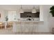 Open-concept kitchen featuring a breakfast bar with pendant lighting and sleek countertops, perfect for casual dining at 3114 S 155Th Ln, Goodyear, AZ 85338