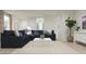 Inviting living room with a large sectional sofa and a neutral color palette, perfect for relaxation at 3114 S 155Th Ln, Goodyear, AZ 85338