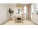 Stylish home office featuring a wooden desk, comfortable chair, large windows, and modern decor at 3114 S 155Th Ln, Goodyear, AZ 85338