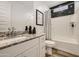 Modern bathroom showcasing granite counters, white cabinets, and a shower-tub combo at 3254 E Ranchhand Dr, San Tan Valley, AZ 85140