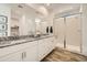 Modern bathroom featuring dual vanities, granite countertops, white cabinetry, and a glass-enclosed shower at 3254 E Ranchhand Dr, San Tan Valley, AZ 85140