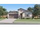 Charming single-story home showcasing a neutral color palette, stone accents, and a well-manicured lawn at 3254 E Ranchhand Dr, San Tan Valley, AZ 85140