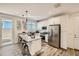 Bright kitchen with granite counters, stainless appliances, island, and wood-look tile floors at 3254 E Ranchhand Dr, San Tan Valley, AZ 85140