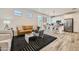 Cozy living room showcasing a modern kitchen with a stylish kitchen island, hardwood floors, and bright natural light at 3254 E Ranchhand Dr, San Tan Valley, AZ 85140