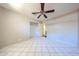 Bedroom featuring tiled floors, a ceiling fan, and a closet for ample storage at 3513 W Maryland Ave, Phoenix, AZ 85019