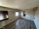 Bedroom with wood flooring, two windows, and views of a connected bathroom at 3513 W Maryland Ave, Phoenix, AZ 85019