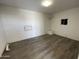 A bedroom featuring wood flooring and a small window at 3513 W Maryland Ave, Phoenix, AZ 85019