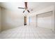 Spacious bedroom featuring tile flooring, a closet, and a ceiling fan at 3513 W Maryland Ave, Phoenix, AZ 85019