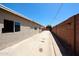 Exterior view of the side yard, featuring a private space along the house's length at 3513 W Maryland Ave, Phoenix, AZ 85019