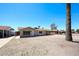 Front view of a single-story home featuring desert landscaping and mature palm trees in the neighborhood at 3513 W Maryland Ave, Phoenix, AZ 85019