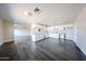 Open-concept space featuring a kitchen with white cabinets, granite counters, and wood-look laminate flooring at 3513 W Maryland Ave, Phoenix, AZ 85019