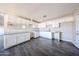 Bright kitchen with white cabinets, gray countertops, and modern vinyl flooring at 3513 W Maryland Ave, Phoenix, AZ 85019
