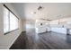 Bright eat-in kitchen features white cabinets, granite countertops, and sleek laminate wood flooring at 3513 W Maryland Ave, Phoenix, AZ 85019