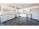 Bright kitchen with white cabinets, gray countertops, and modern vinyl flooring at 3513 W Maryland Ave, Phoenix, AZ 85019