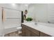 Well-lit bathroom featuring tiled shower over tub, wood-look floors, stylish vanity and decorative mirror at 3752 E Terrel St, San Tan Valley, AZ 85143