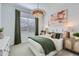 Serene bedroom featuring a decorative brick wall, modern light fixtures, and neutral decor at 3752 E Terrel St, San Tan Valley, AZ 85143